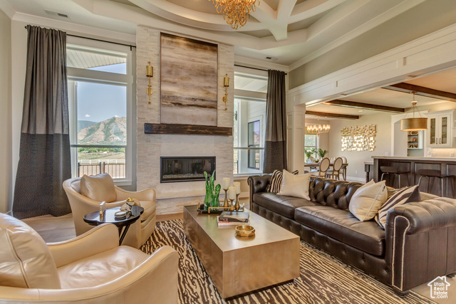 1547 North 1350 E Street, Unit 2 Mapleton, UT 84664 - Photo 8 of 18 Living room with a chandelier, beam ceiling, a large fireplace, healthy amount of natural light, and ornamental molding