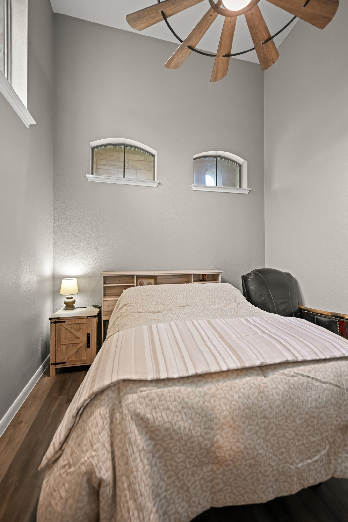 5528 Wild Foxglove Road Spicewood, TX 78669 - Photo 18 of 38 a bed room with a bed and a chandelier