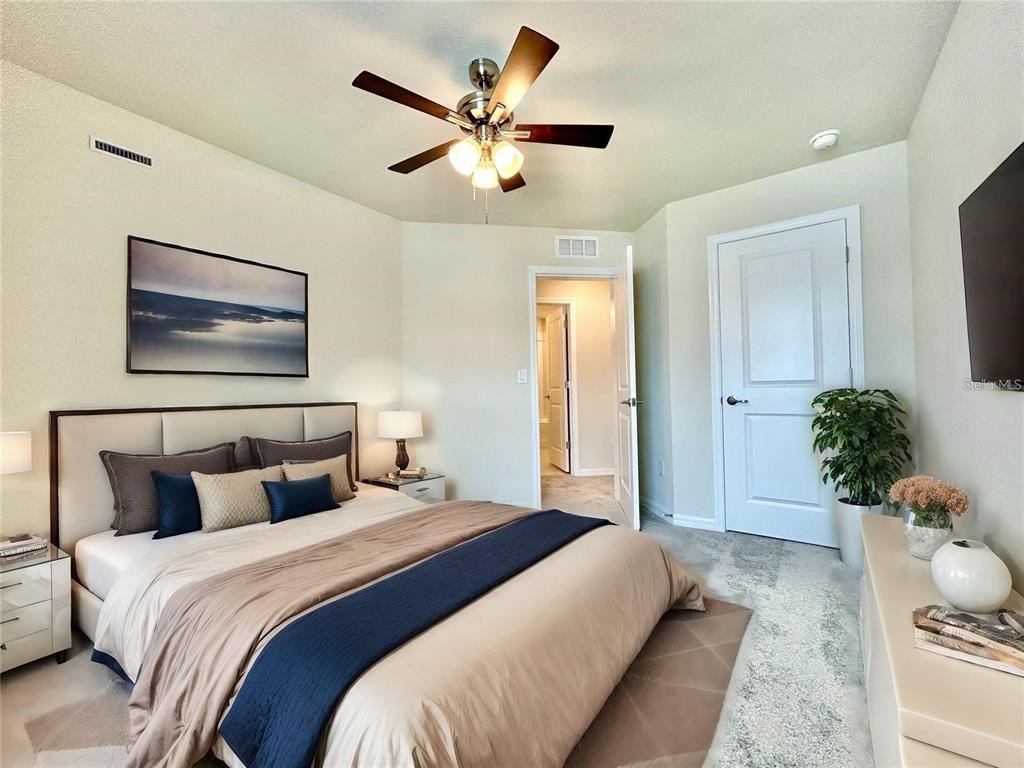 4652 Sparkling Shell Avenue Kissimmee, FL 34746 - Photo 14 of 35 a bedroom with a bed and a chandelier