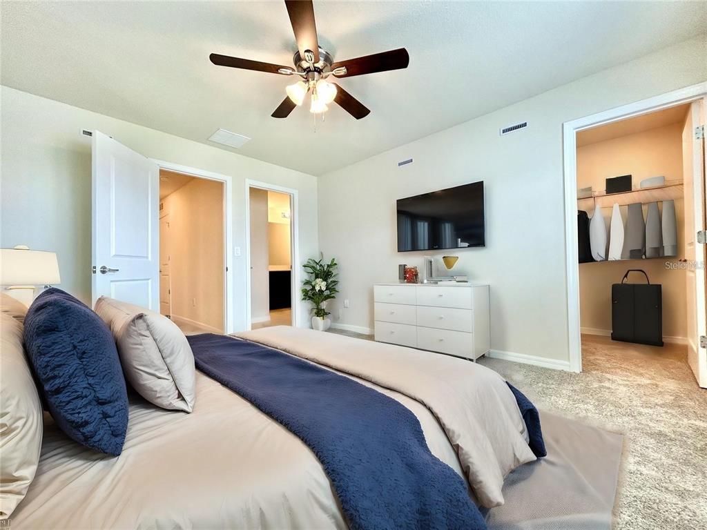 4652 Sparkling Shell Avenue Kissimmee, FL 34746 - Photo 17 of 35 a bedroom with a bed window and flat screen tv