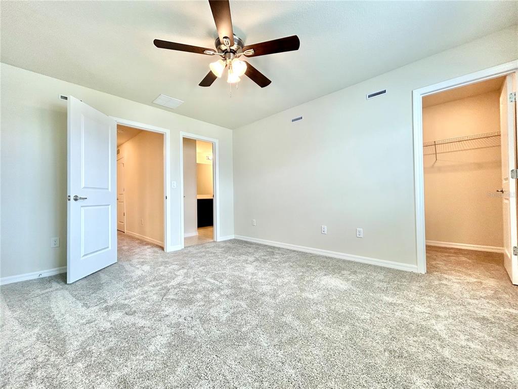 4652 Sparkling Shell Avenue Kissimmee, FL 34746 - Photo 18 of 35 an empty room with closet and windows