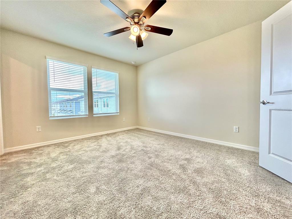 4652 Sparkling Shell Avenue Kissimmee, FL 34746 - Photo 20 of 35 a view of an empty room with a window