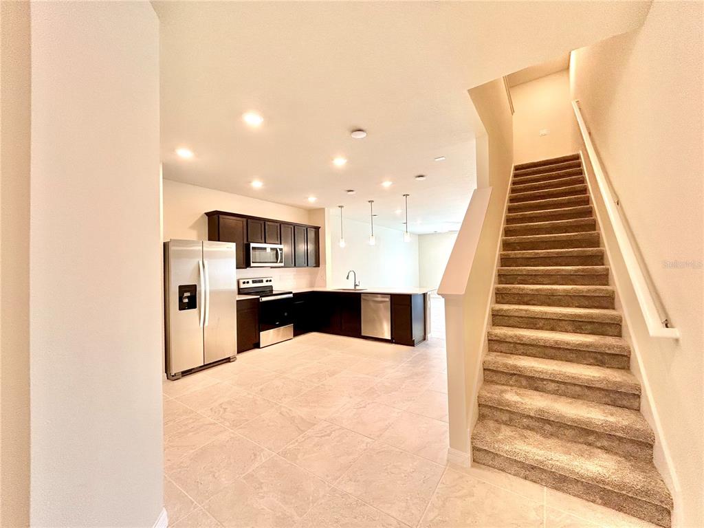 4652 Sparkling Shell Avenue Kissimmee, FL 34746 - Photo 2 of 35 a view of kitchen with wooden floor and electronic appliances