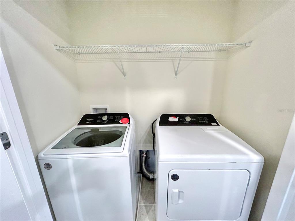 4652 Sparkling Shell Avenue Kissimmee, FL 34746 - Photo 25 of 35 a utility room with dryer and washer