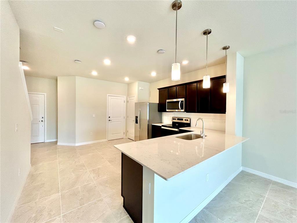 4652 Sparkling Shell Avenue Kissimmee, FL 34746 - Photo 6 of 35 a view of a kitchen and a microwave