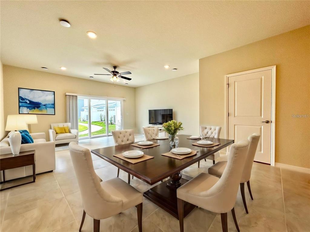 4652 Sparkling Shell Avenue Kissimmee, FL 34746 - Photo 7 of 35 a view of a dining room with furniture