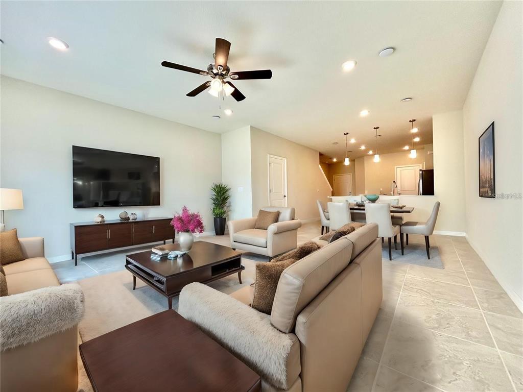 4652 Sparkling Shell Avenue Kissimmee, FL 34746 - Photo 9 of 35 a living room with furniture and a flat screen tv