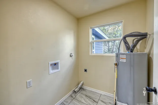 an empty room with fan and windows