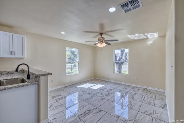 a kitchen with stainless steel appliances granite countertop a sink stove and cabinets