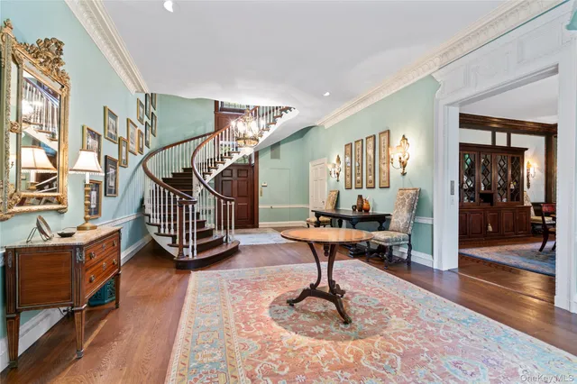 a living room with wooden floor and a table chair