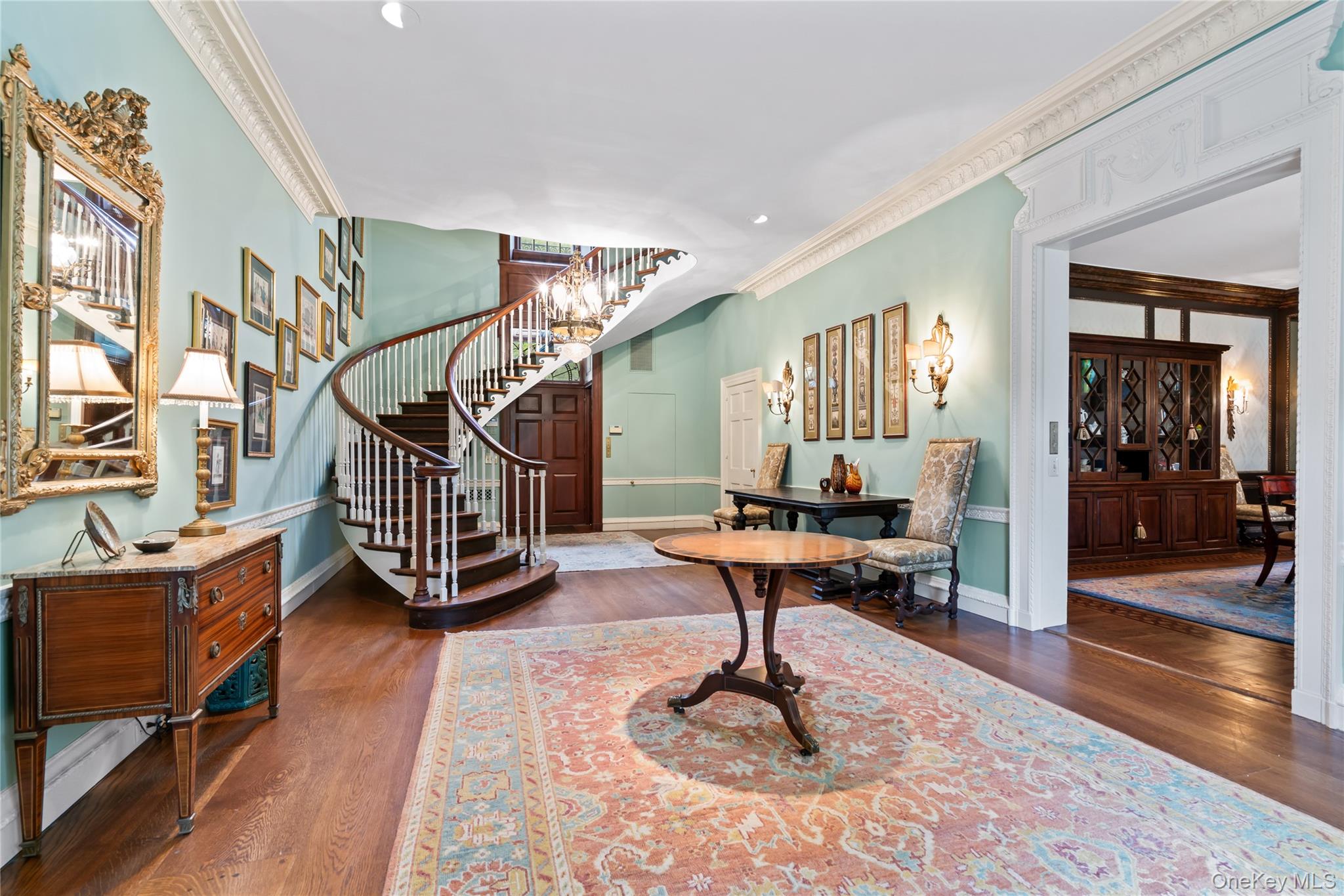 88 Wheatley Road Old Westbury, NY 11568 - Photo 14 of 40 Foyer featuring ornamental molding, dark wood-style flooring, a chandelier, recessed lighting, and stairway
