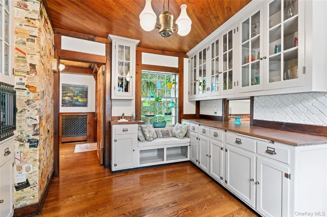 a large white kitchen with a large window