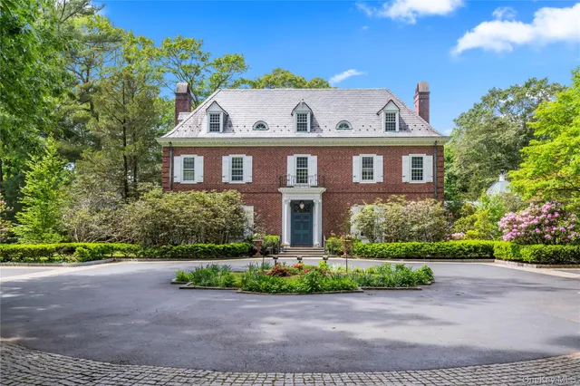 a front view of a house with a yard and a garage