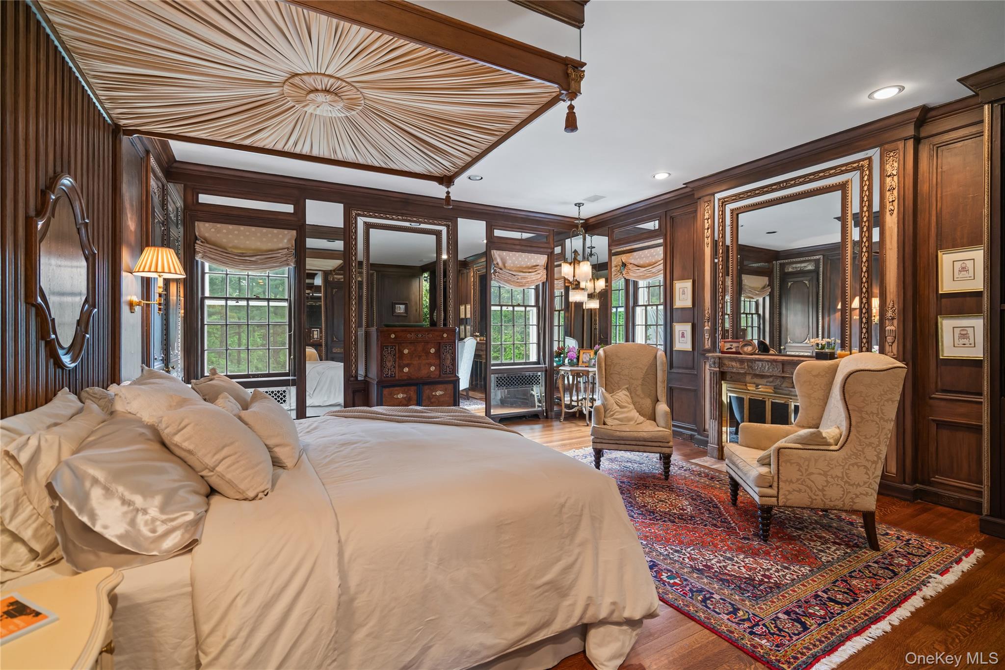 88 Wheatley Road Old Westbury, NY 11568 - Photo 24 of 40 Bedroom with ornamental molding, a chandelier, wood finished floors, multiple windows, and recessed lighting