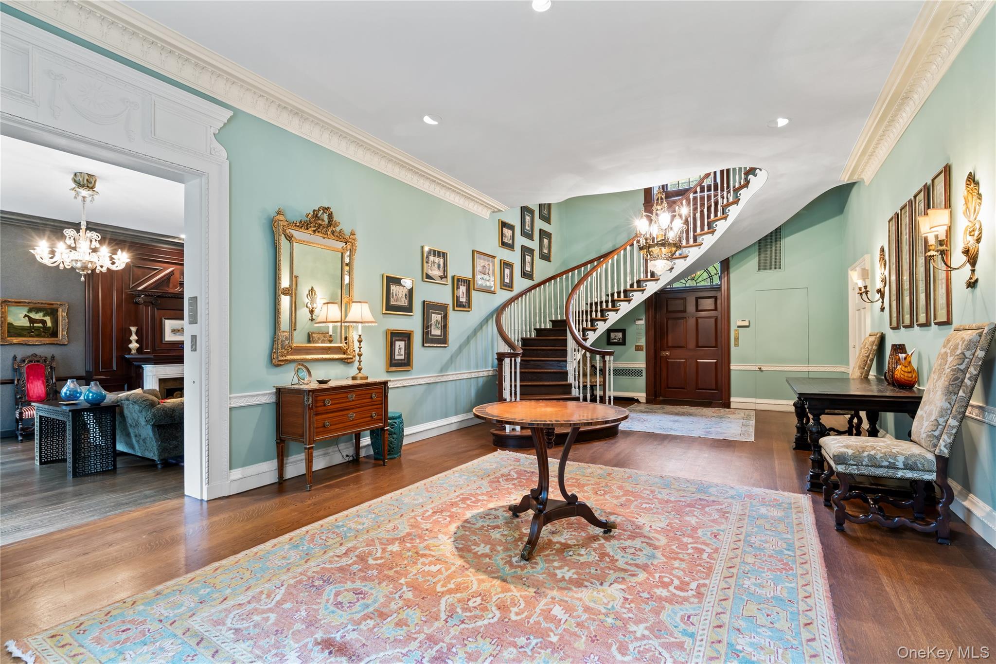 88 Wheatley Road Old Westbury, NY 11568 - Photo 3 of 40 Entrance foyer featuring a chandelier, crown molding, dark wood-style flooring, recessed lighting, and stairs