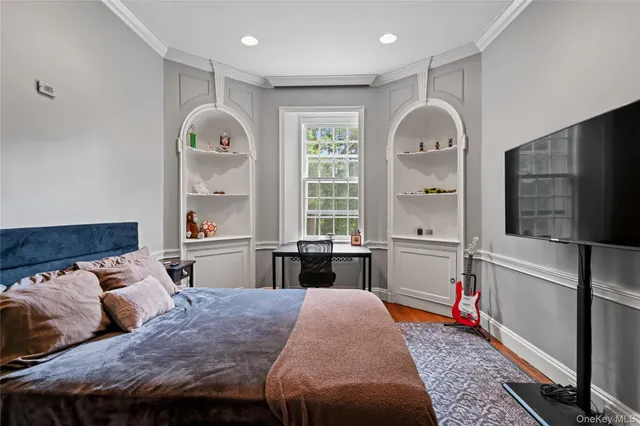 a bed room with a bed window and a television