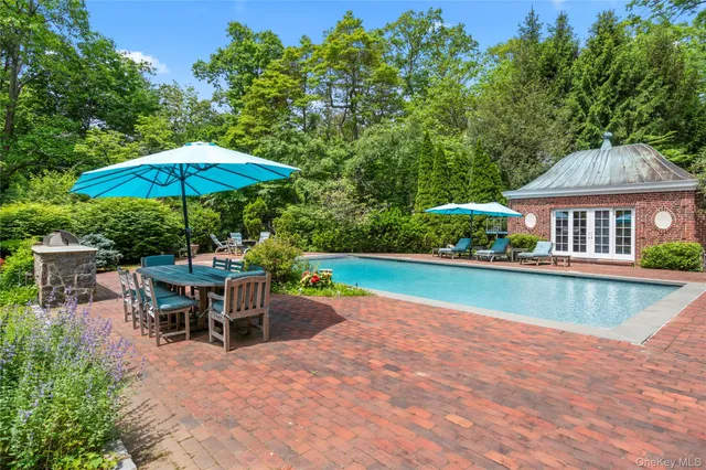an outdoor space with swimming pool and furniture