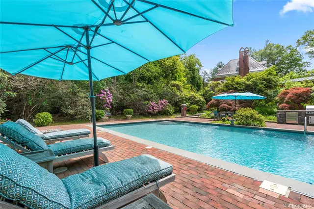 swimming pool view with a seating space