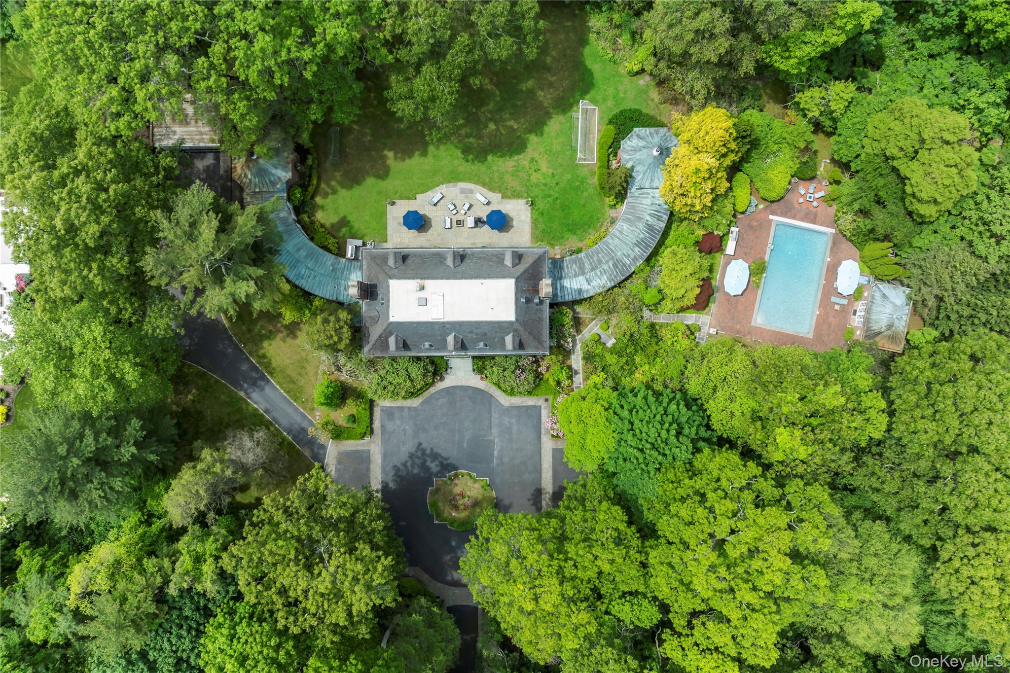 88 Wheatley Road Old Westbury, NY 11568 - Photo 38 of 40 Aerial overview of property's location with a pool and a tree filled landscape