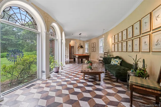 a living room with furniture and a floor to ceiling window