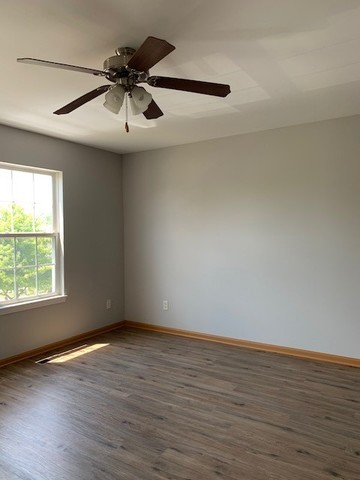 707 Shannon Drive Romeoville, IL 60446 - Photo 11 of 14 an empty room with wooden floor and windows