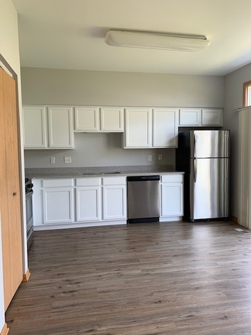 707 Shannon Drive Romeoville, IL 60446 - Photo 3 of 14 a kitchen with granite countertop a refrigerator and a stove top oven