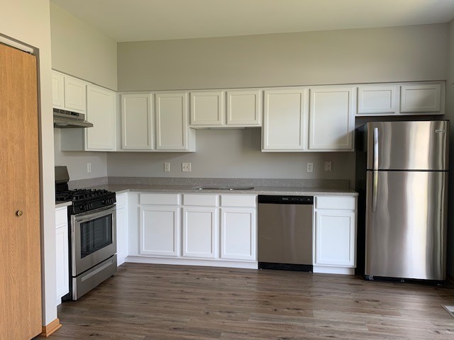 707 Shannon Drive Romeoville, IL 60446 - Photo 4 of 14 a kitchen with a refrigerator stove top oven and cabinets