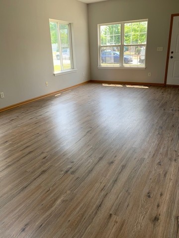 707 Shannon Drive Romeoville, IL 60446 - Photo 7 of 14 an empty room with wooden floor and windows