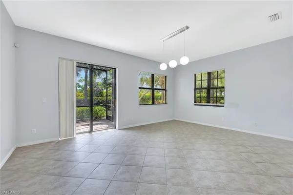 an empty room with windows and outdoor view