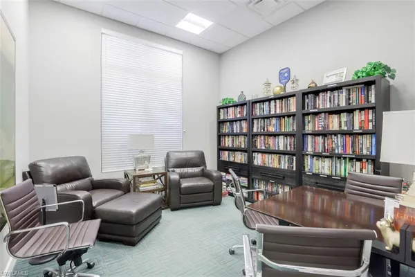 a living room with furniture and a book shelf