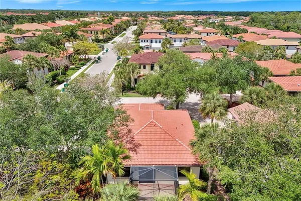 an aerial view of residential houses with outdoor space and trees