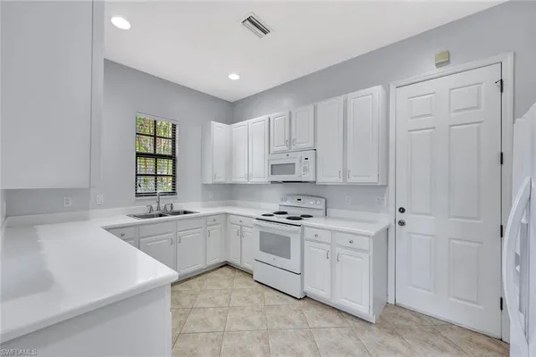 a kitchen with a sink stove and cabinets
