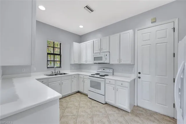 a kitchen with a sink stove and cabinets
