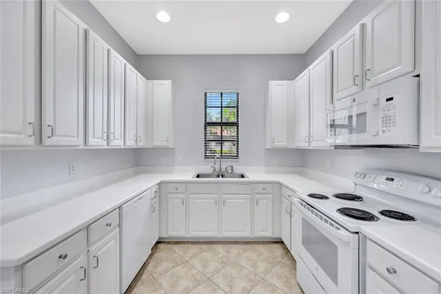 a kitchen with cabinets appliances a sink and a counter top