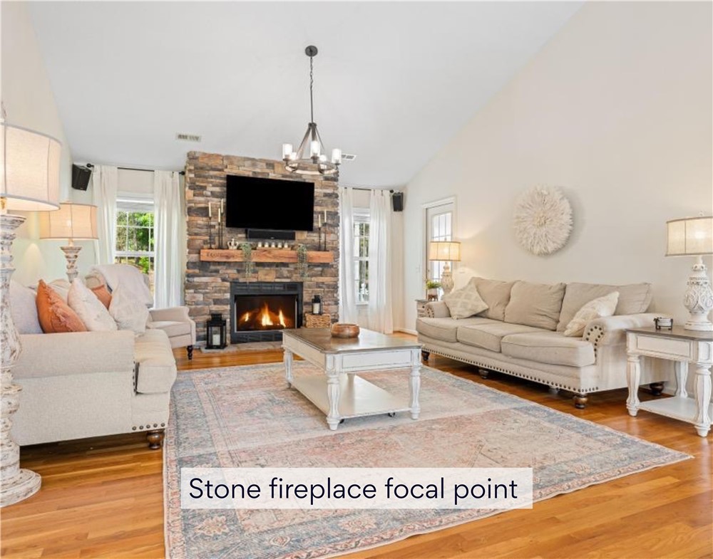 848 Perkins Creek Road Seneca, SC 29678 - Photo 7 of 26 A spacious great room showcases a towering stone fireplace, anchoring the warm, inviting atmosphere.