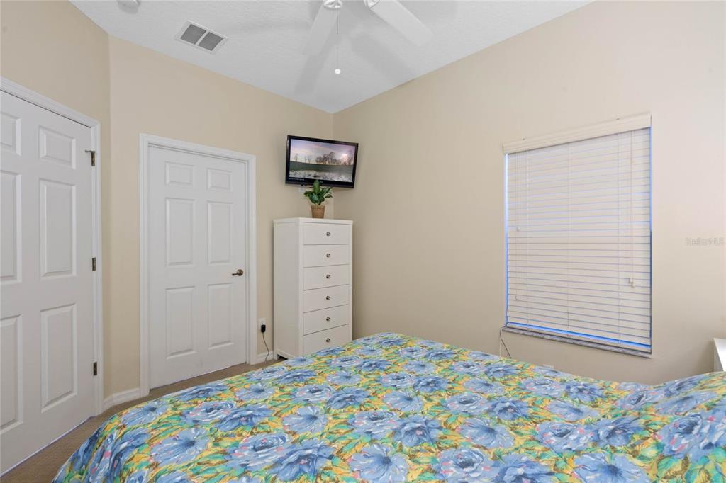 8535 Bay Lilly Loop Kissimmee, FL 34747 - Photo 12 of 57 a bedroom with a bed and a window