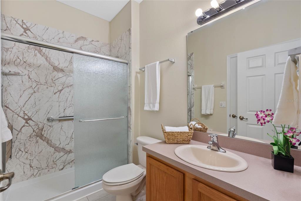 8535 Bay Lilly Loop Kissimmee, FL 34747 - Photo 14 of 57 a bathroom with a sink toilet and shower