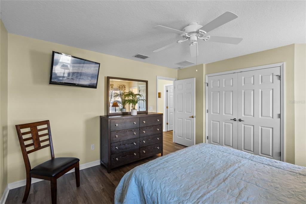 8535 Bay Lilly Loop Kissimmee, FL 34747 - Photo 18 of 57 a bedroom with a bed and a dresser in it