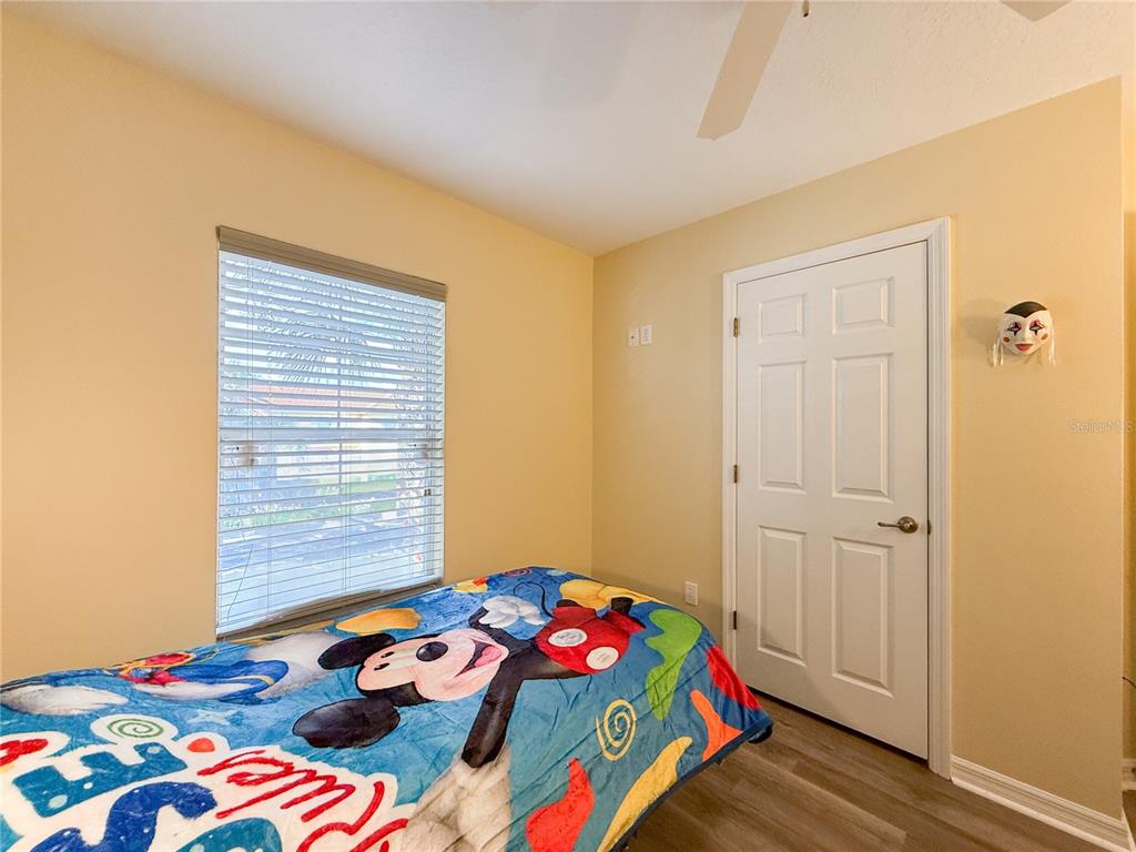 8535 Bay Lilly Loop Kissimmee, FL 34747 - Photo 22 of 57 a bedroom with a bed and a window