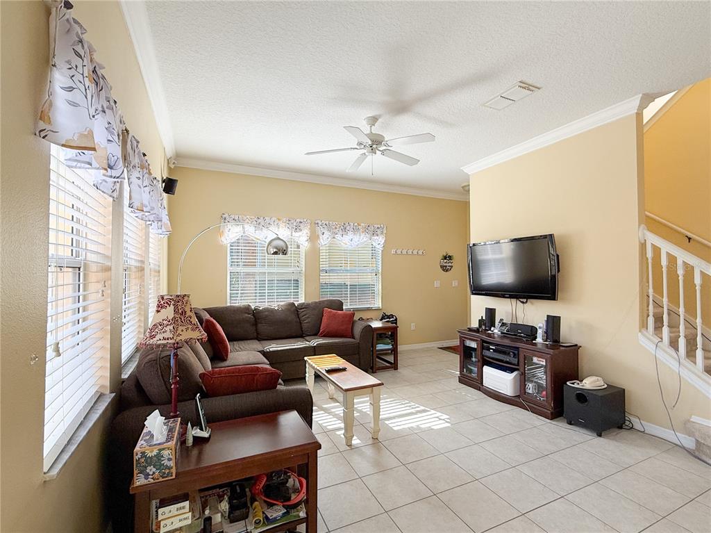 8535 Bay Lilly Loop Kissimmee, FL 34747 - Photo 5 of 57 a living room with furniture and a flat screen tv