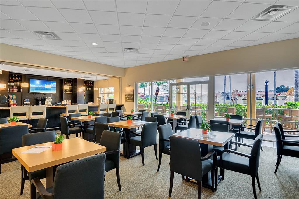 8535 Bay Lilly Loop Kissimmee, FL 34747 - Photo 52 of 57 a room with lots of tables a large window and chairs