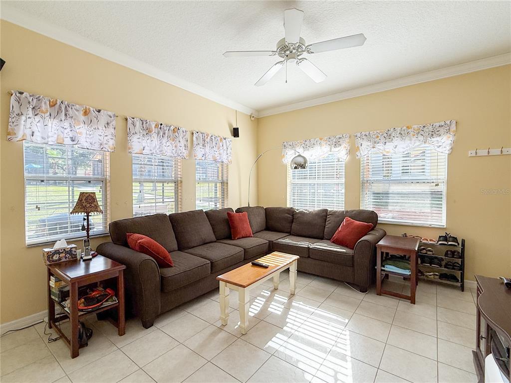 8535 Bay Lilly Loop Kissimmee, FL 34747 - Photo 6 of 57 a living room with furniture and a large window