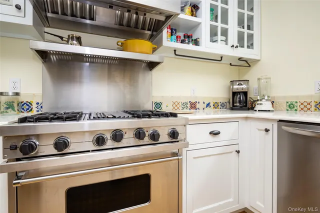 a white stove top oven sitting inside of a kitchen