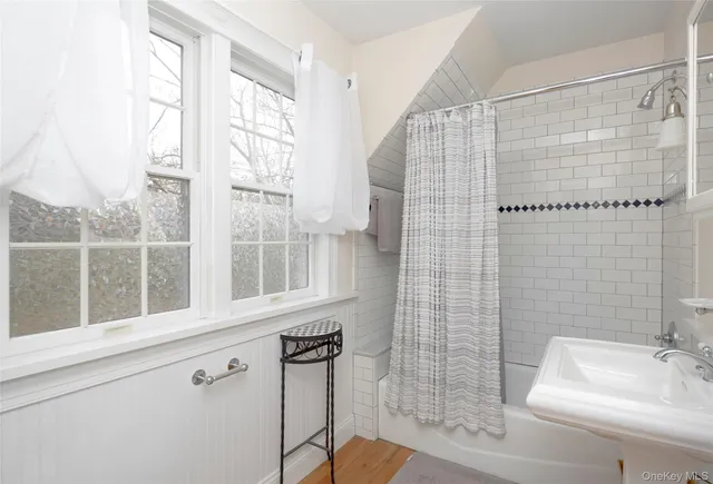 a bathroom with a shower and a sink
