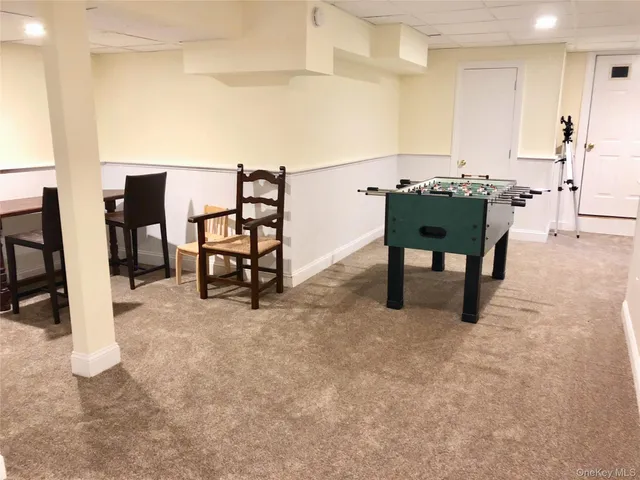 a view of a dining room with furniture and a kitchen