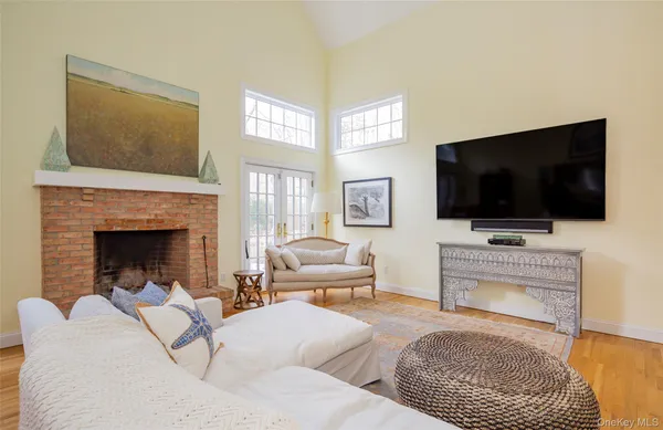 a living room with furniture a flat screen tv and a fireplace