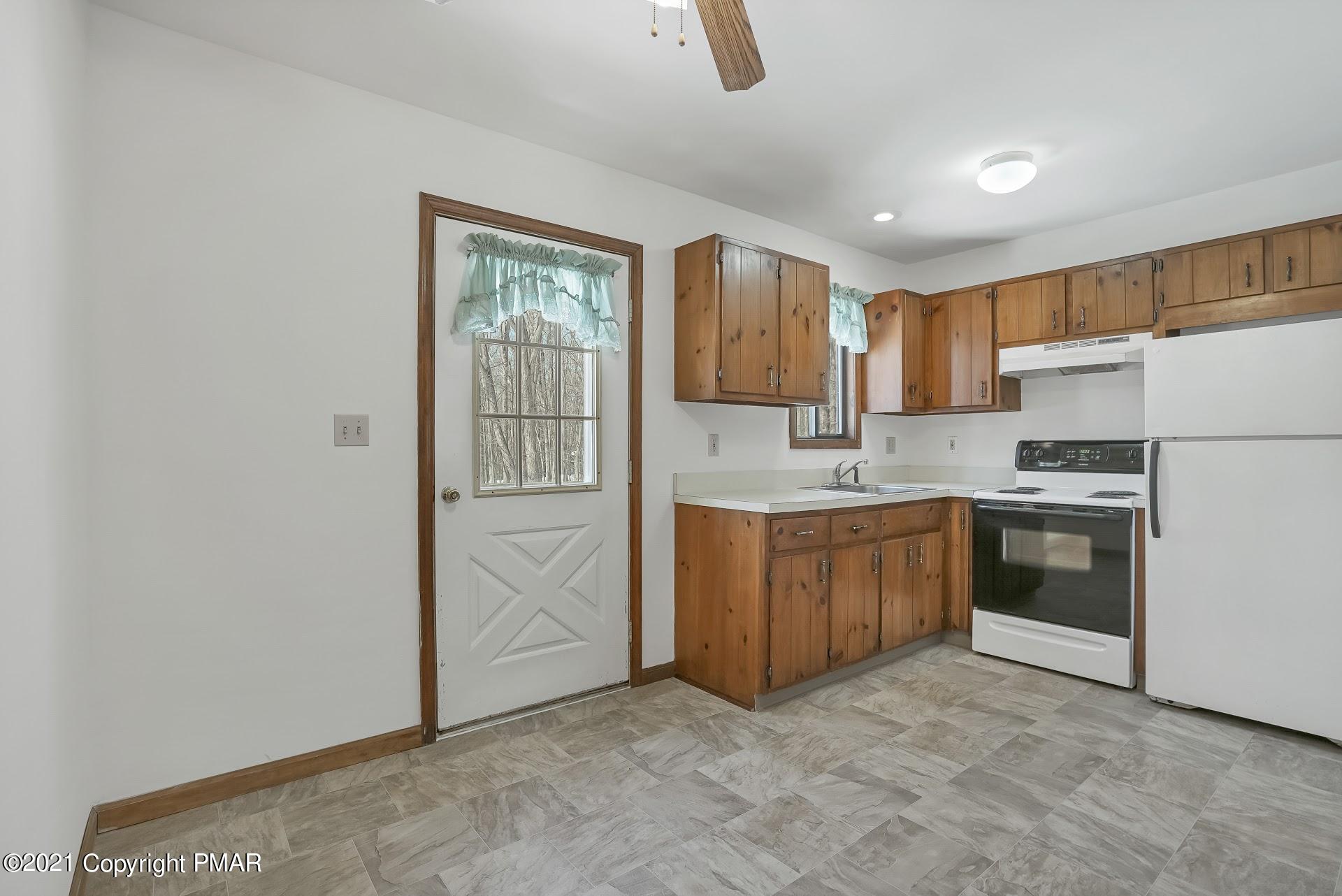 1908 Johns Road Effort, PA 18330 - Photo 6 of 23 a kitchen with white cabinets and white appliances