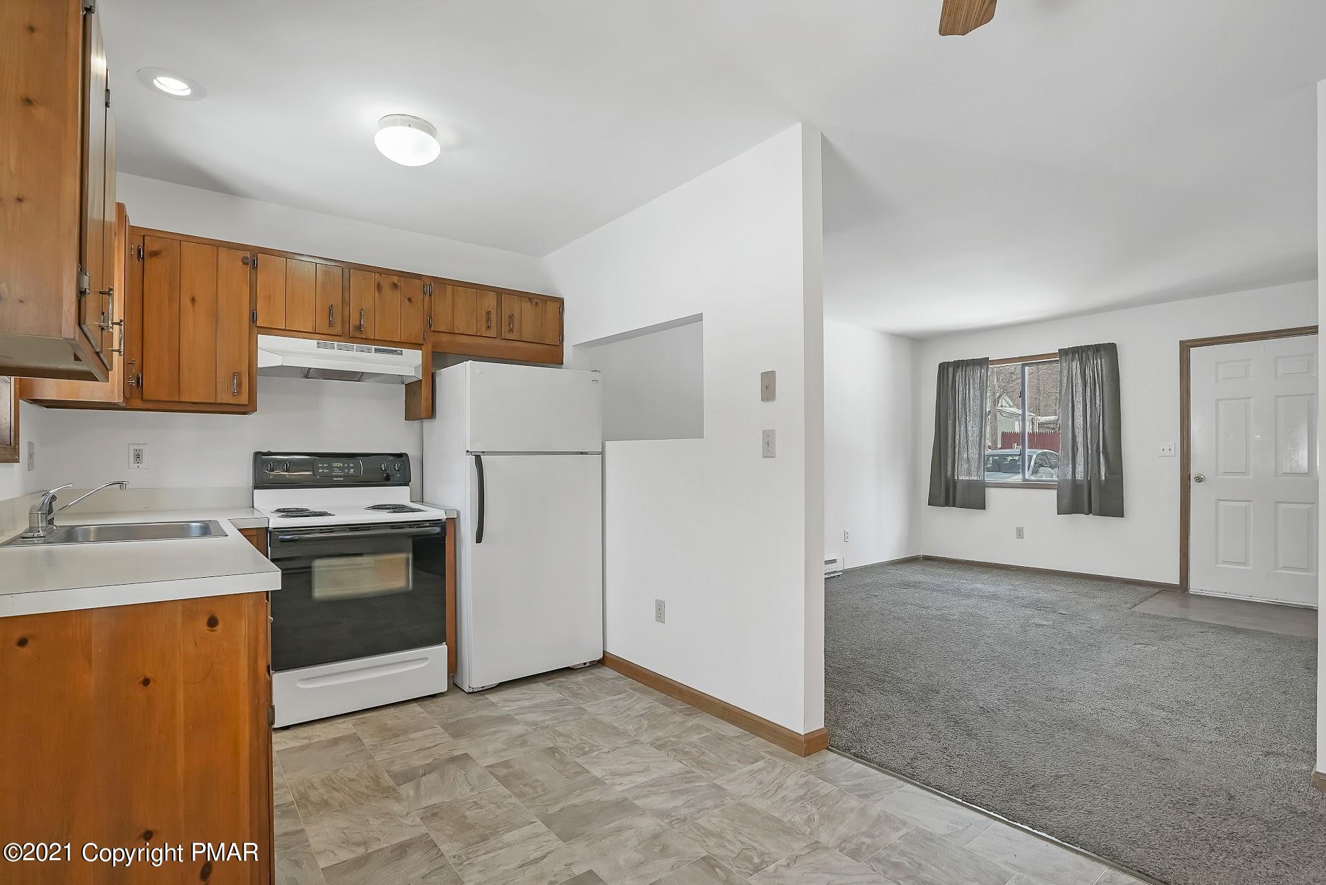 1908 Johns Road Effort, PA 18330 - Photo 7 of 23 a kitchen with stainless steel appliances granite countertop a stove a refrigerator and a sink