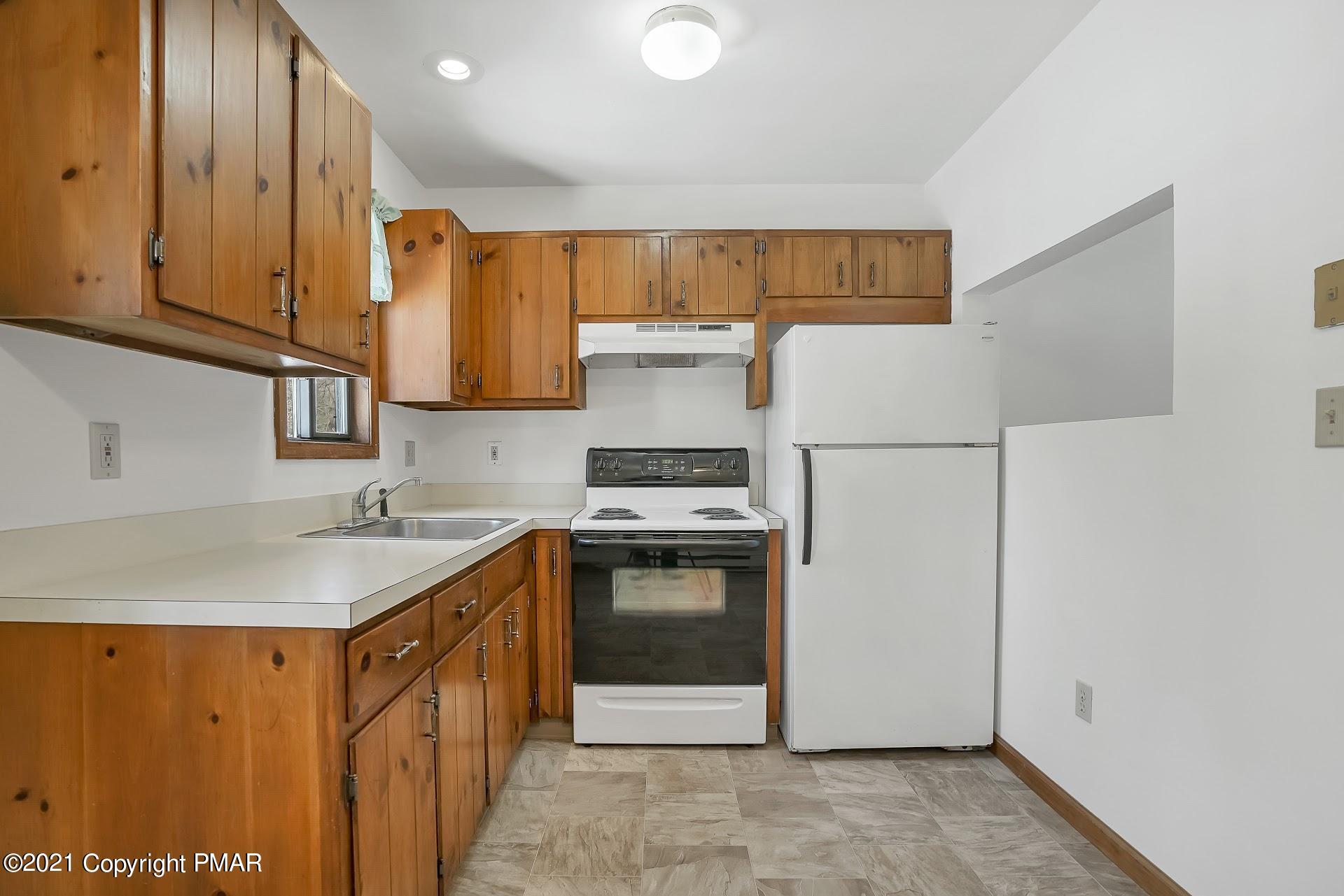 1908 Johns Road Effort, PA 18330 - Photo 8 of 23 a kitchen with stainless steel appliances granite countertop a stove a sink and a refrigerator
