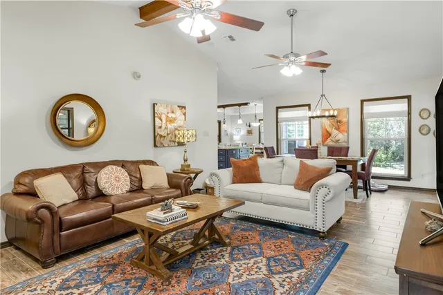 a living room with furniture a fireplace and a flat screen tv